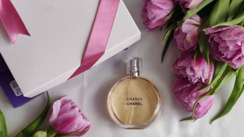 Chanel chance perfume bottle with flowers and gift box nearby