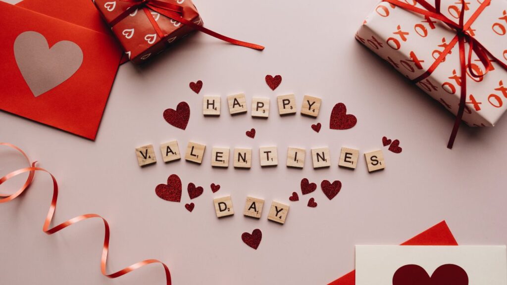 image of a DIY valentines day gift card with gift boxes and happy valentines day being written in the middle