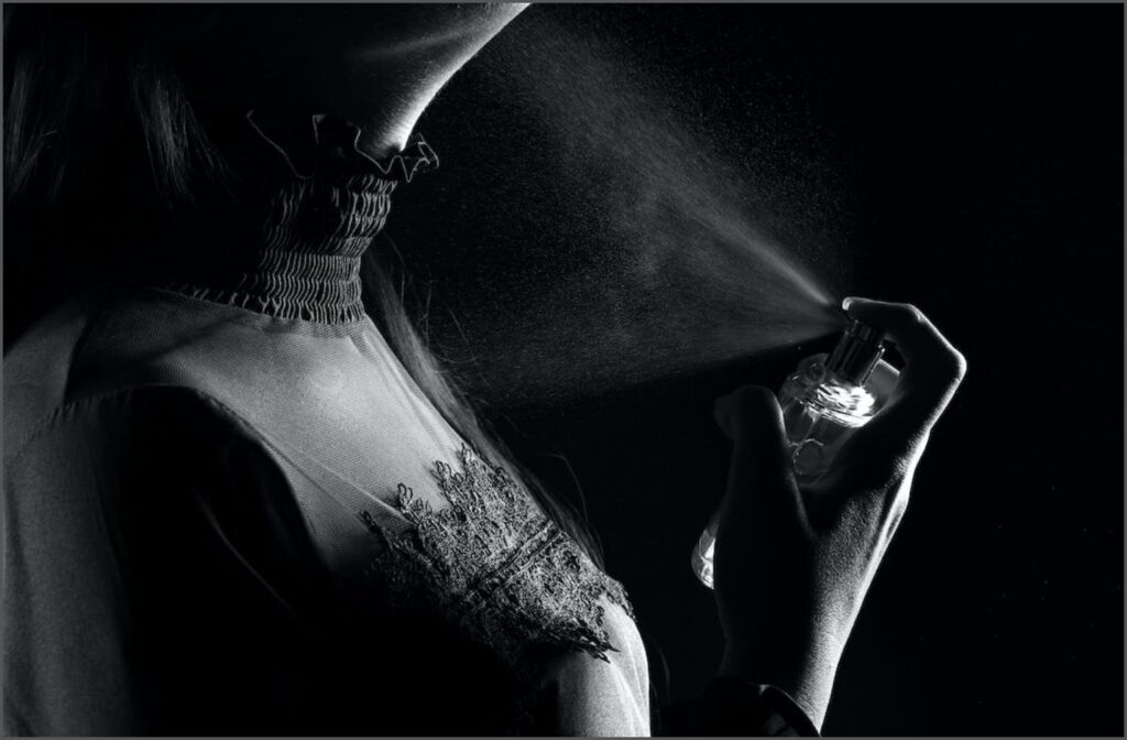 A girl applying perfume, in Black and White