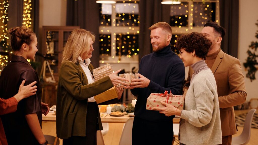 image of a group of people sharing gifts in an indoor party