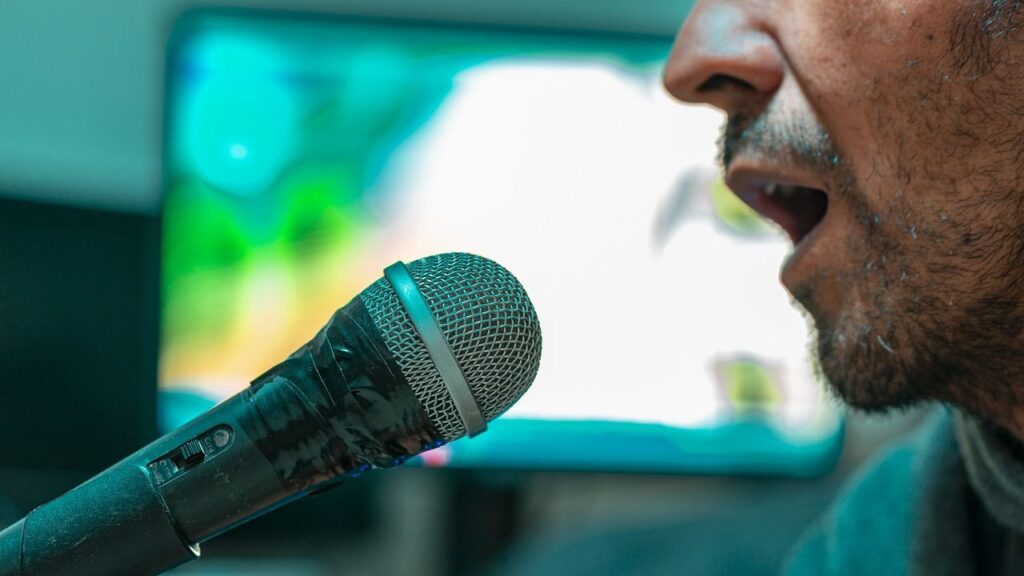 a man singing into a microphone