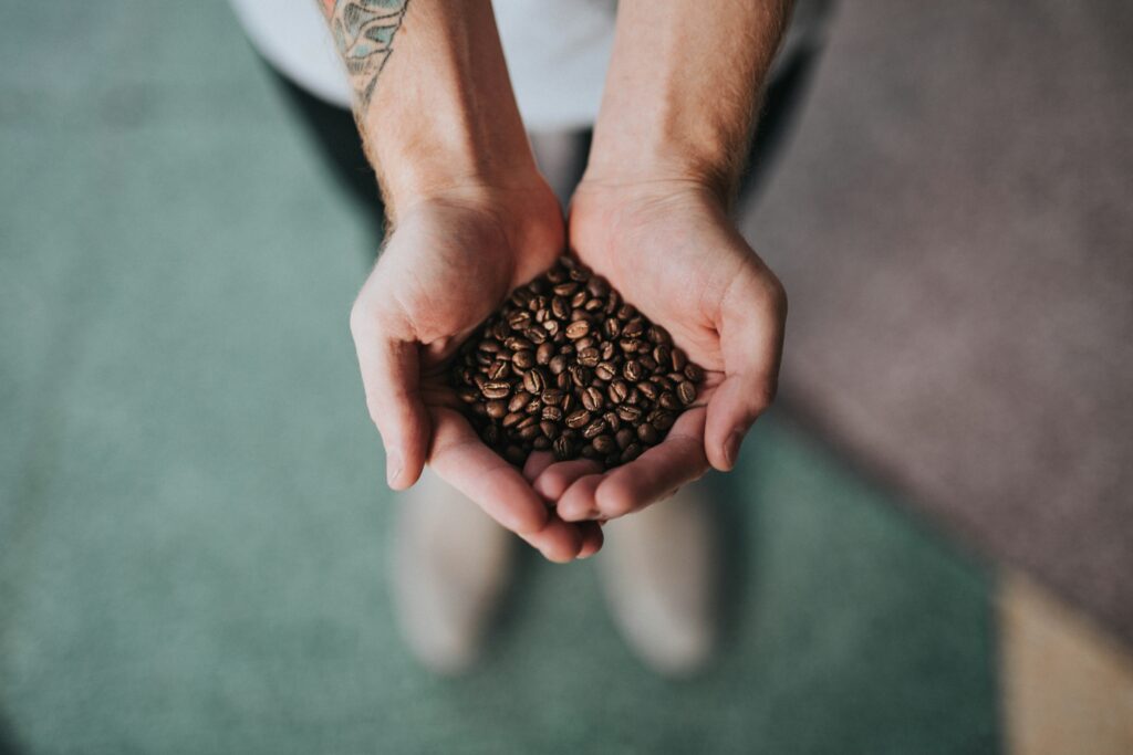 image of coffee beans in a persons hand