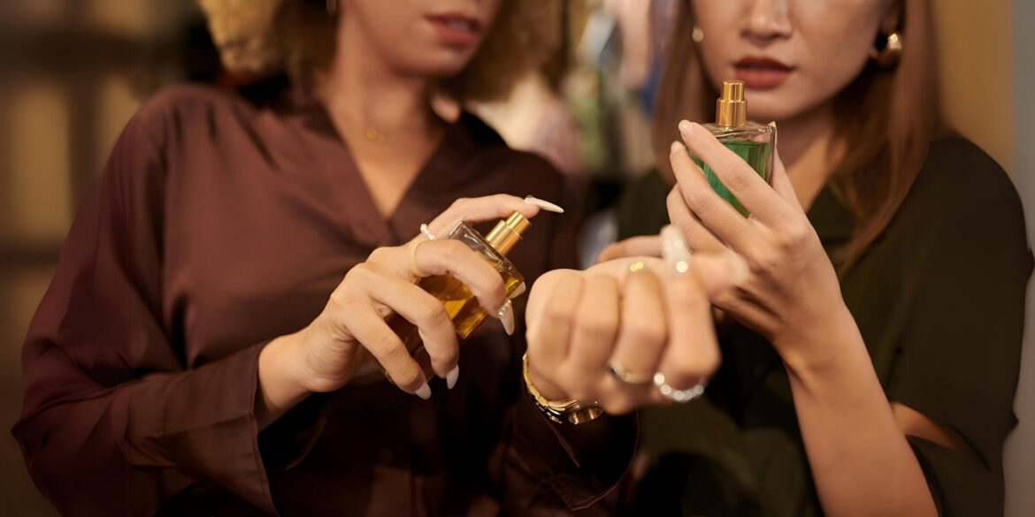 An image of 2 women testing out perfume