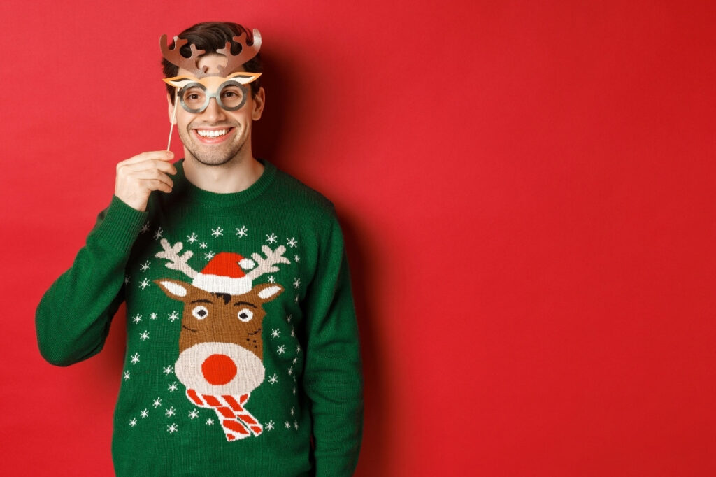 An image of a boy wearing christmas sweater