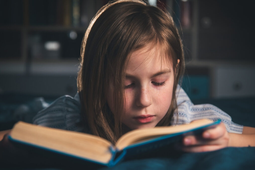 An image of a girl with a book
