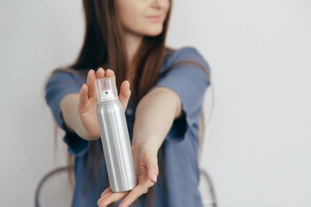 An image of a girl showing her body spray