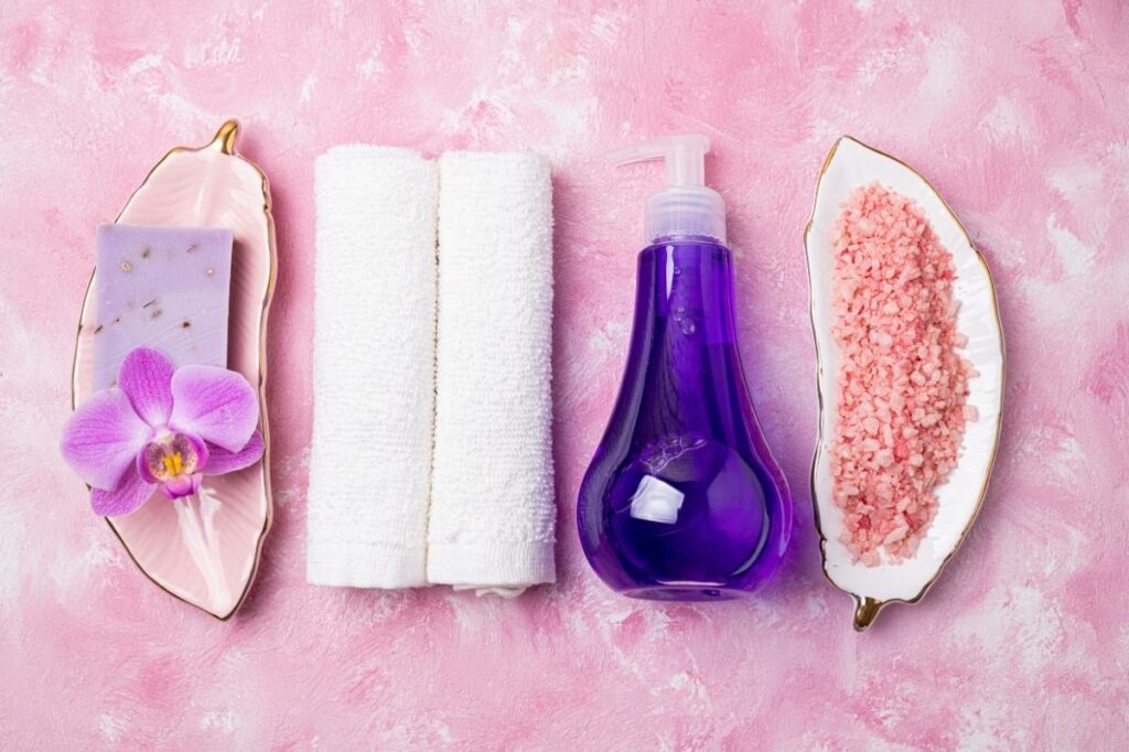 An image of a body lotion, towel and spa necessary items