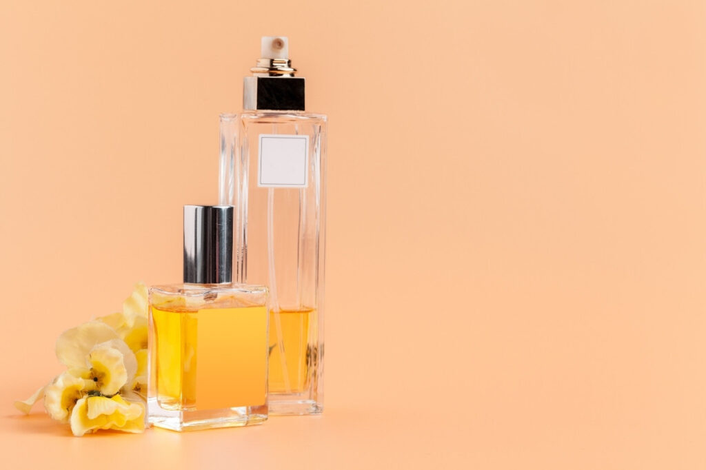 An image of a perfume bottle and a perfume oil bottle nearby