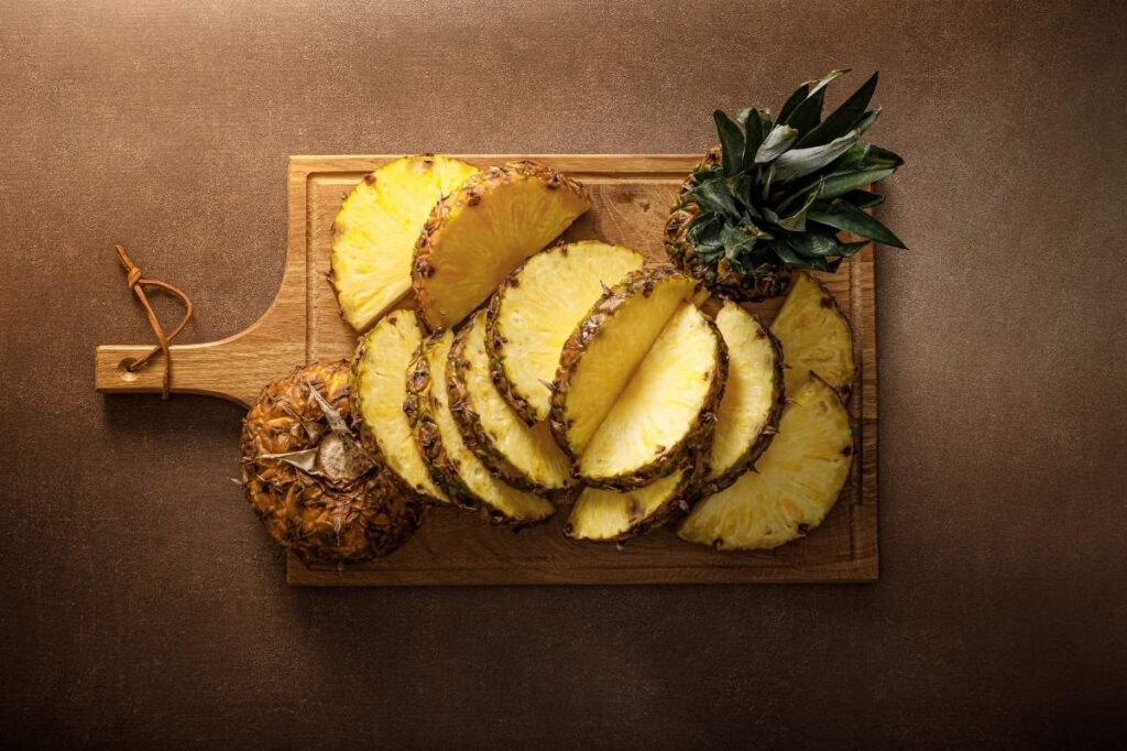 Foods That Make Your Body Odor Good 23 An image of a set of sliced pineapples on a cutting board