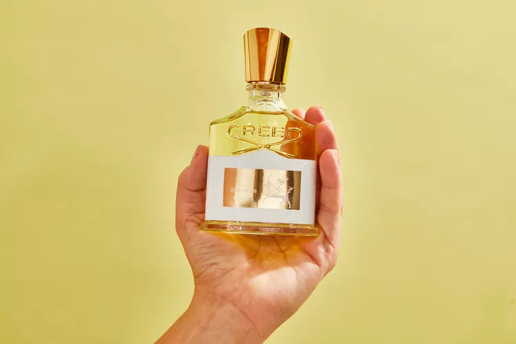 an image of creed aventus for her in the hand of a person