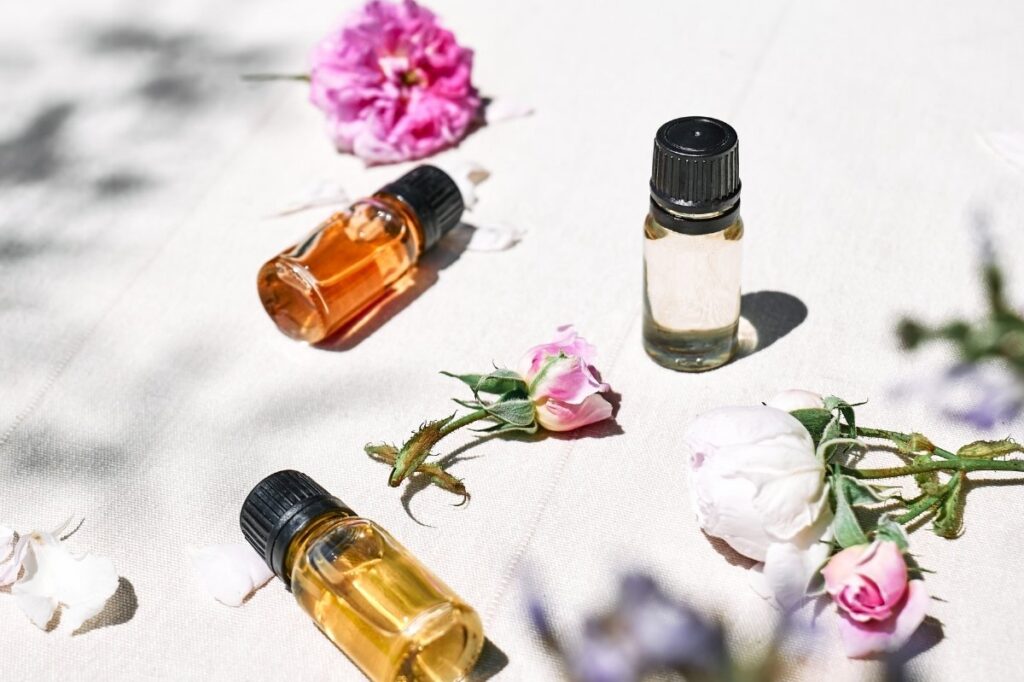 An image of different perfume oils lying down