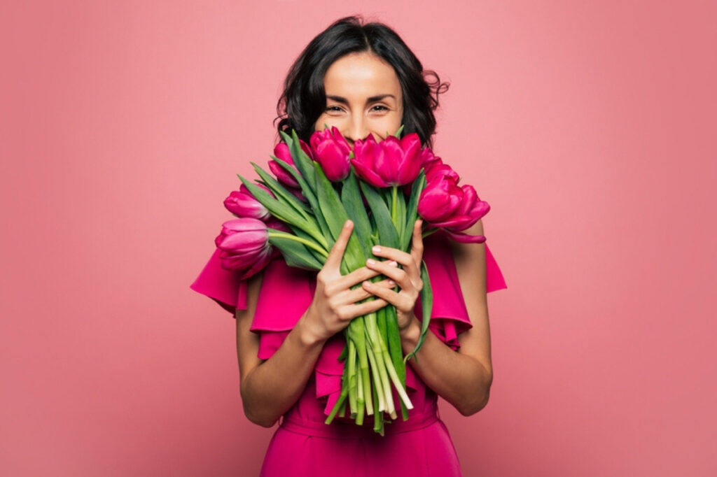 An image of a woman with flowers in hand
