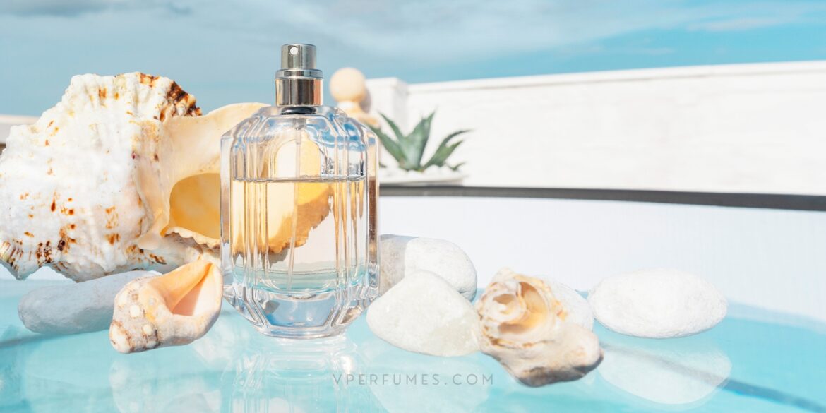 best-summer-perfumes An image of a perfume placed on a surface similar to a beach with shells