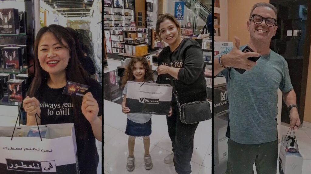 This image is a collage of three happy customers celebrating their wins at a V Perfumes store on the occasion of Youm-al-ottoor. On the left, a young woman with long dark hair, wearing a black t-shirt, smiles while holding a scratch-and-win card and a branded shopping bag. In the center, a mother and her young daughter joyfully pose with a V Perfumes bag, standing inside the store with shelves of fragrances in the background. On the right, a man in a teal t-shirt and glasses gives a thumbs-up while holding his shopping bag, looking excited. The bright and elegant store interior enhances the celebratory mood.