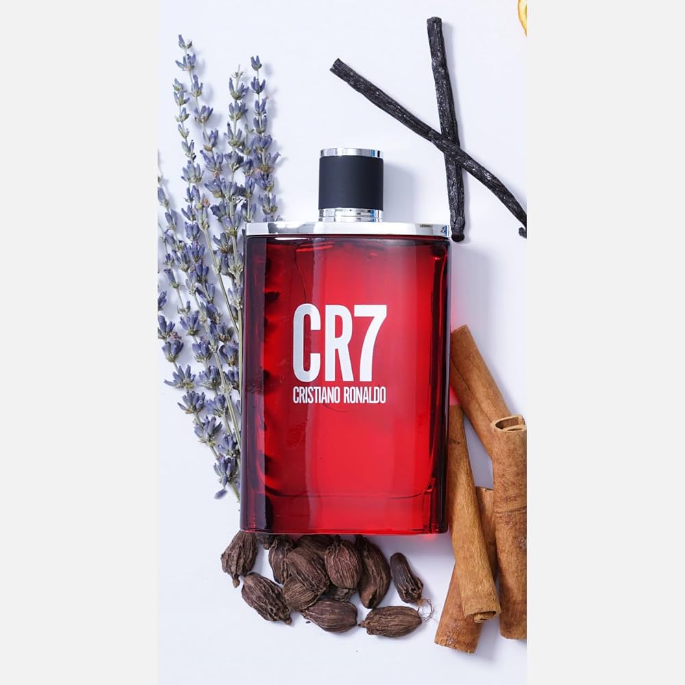 5 Football Stars Who Won the Fragrance Game 22 In this image CR7 Eau de Toilette bottle showcased against a white background, encircled by visual elements representing its fragrance notes: aromatic lavender, spicy cardamom, fresh bergamot, warm cinnamon, rich tobacco, creamy sandalwood, and sensual musk, embodying the dynamic and modern essence of the scent.
