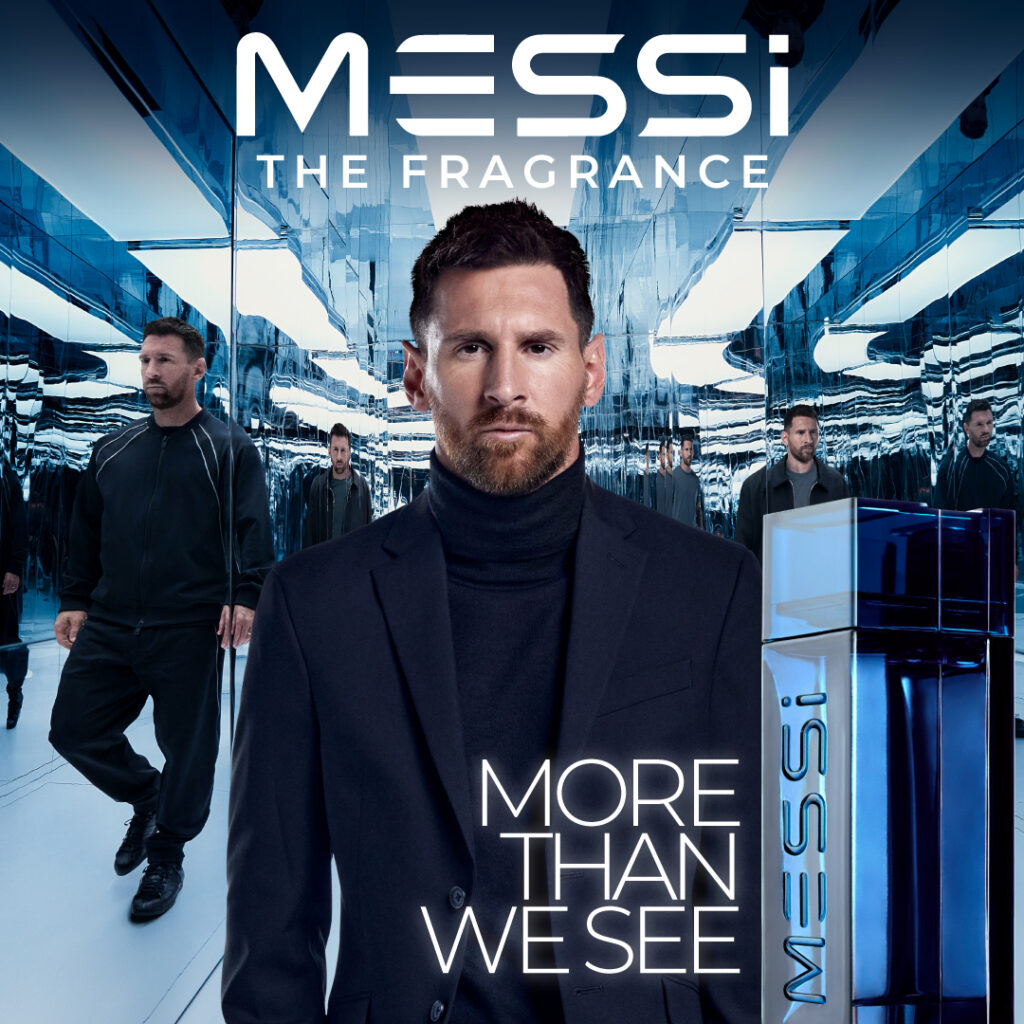 5 Football Stars Who Won the Fragrance Game 18 In this image Lionel Messi stands confidently in a sophisticated dark suit against a reflective, futuristic background featuring multiple reflections of himself. Beside him is a sleek blue bottle of "Messi - The Fragrance" with the tagline "More Than We See" displayed prominently.