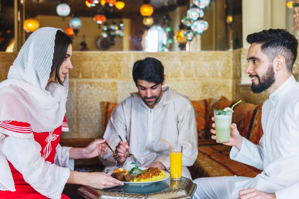 How to Pick the Perfect Ramadan Gift for Everyone 21 An image of 3 friends having ifthar in a restaurant.