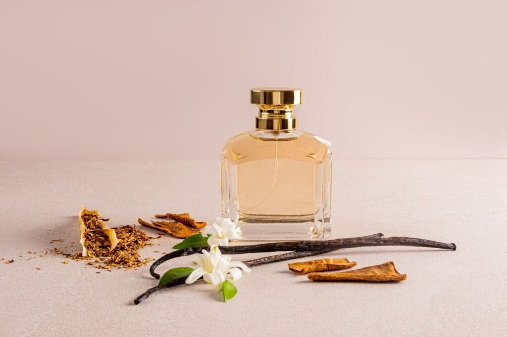 What Really Makes a Perfume Feel Romantic? 19 an image of a perfume bottle in golden color with a minimal luxury background