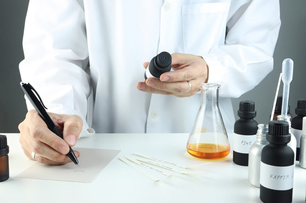 An image of a person mixing ingredients of a perfume and chemicals