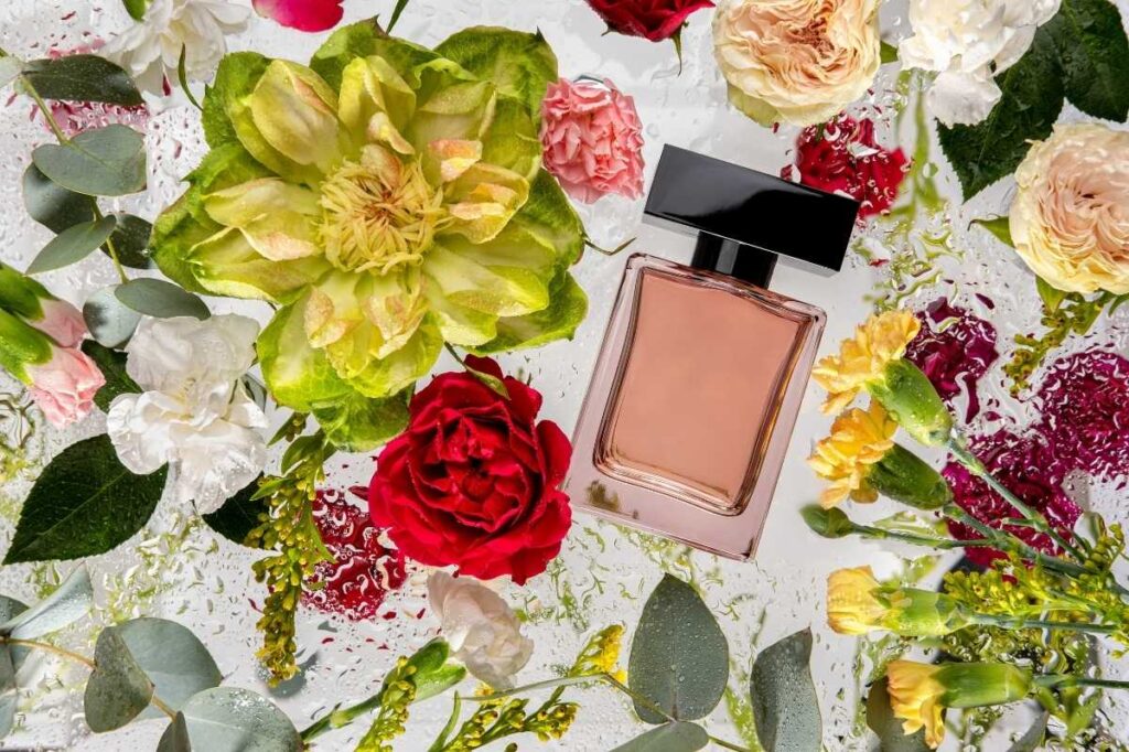 The Best Smelling Flowers Found In Perfumes 26 An image of perfume bottle surrounded by flowers. Product mockup. Fragrance presentation