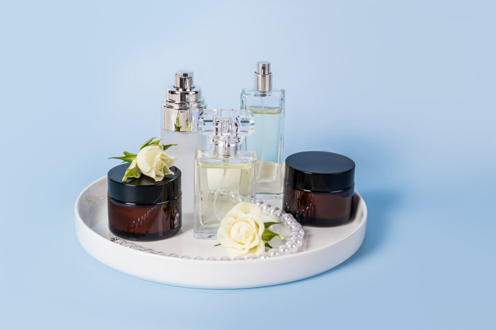 An image of a set of perfumes and beauty items