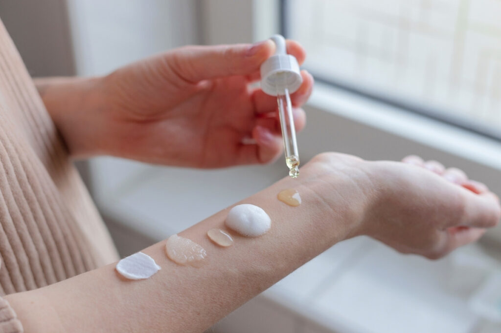An image of a woman testing beauty products on her hand