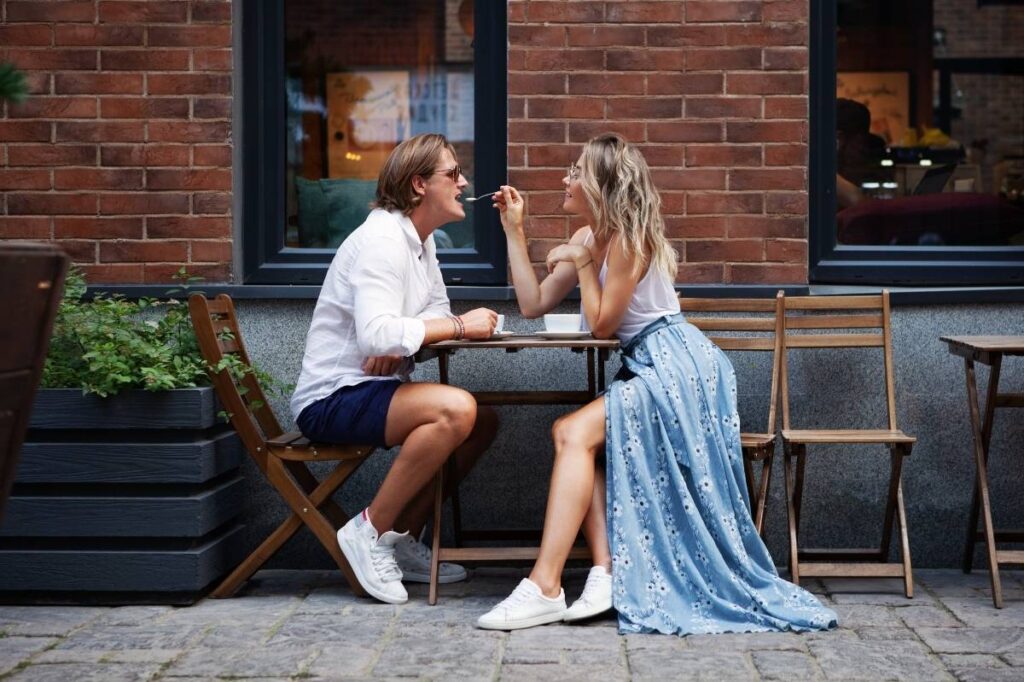 An image of a young couple sitting in a cafe