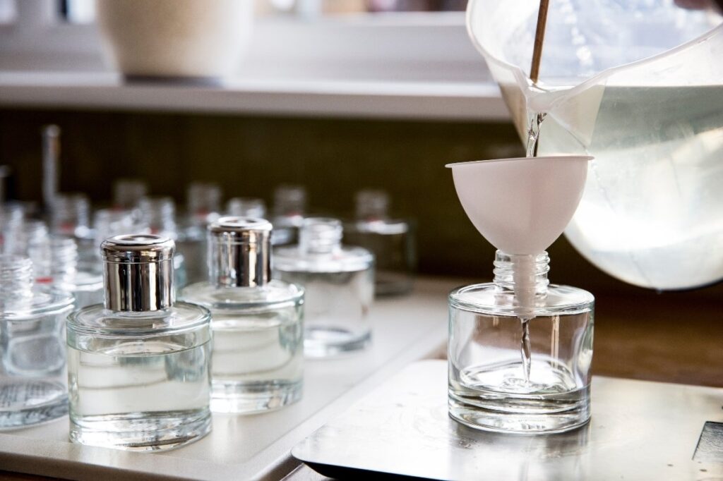 Are Perfume Testers Really Better Than the Ones You Buy 19 An image of a person mixing different cchemicals to create a perfume
