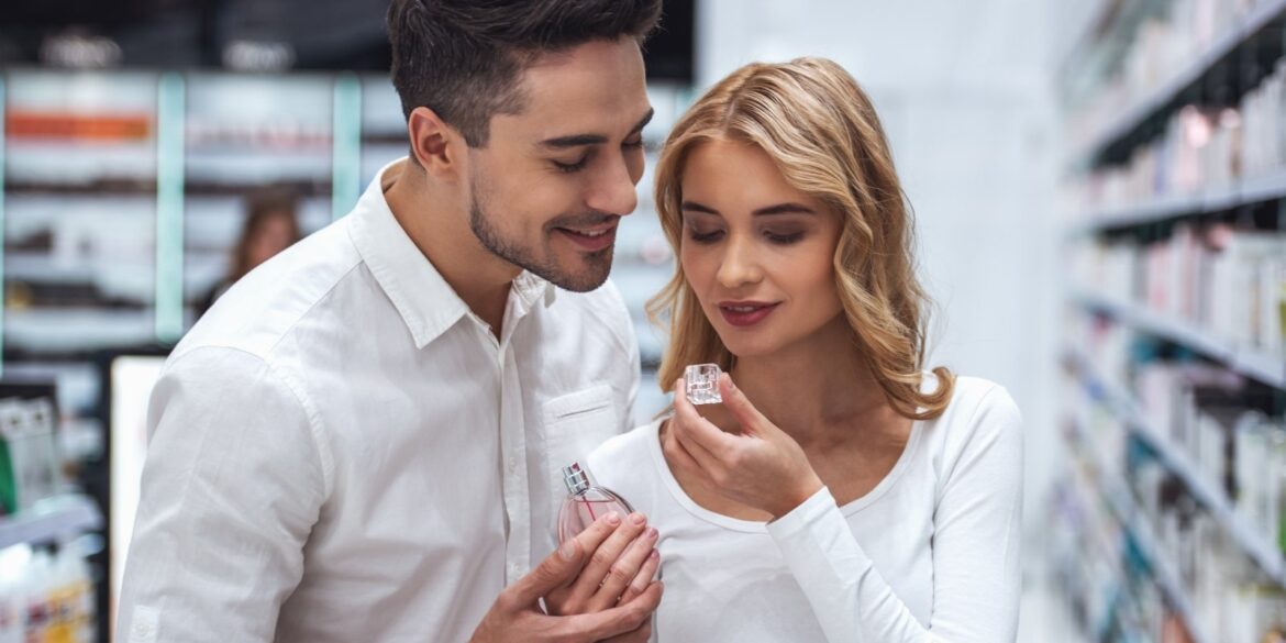 An image of a woman smelling a men perfume