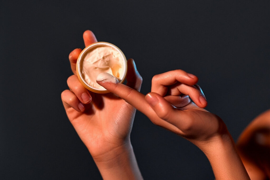 An image of a moisturizer pack and a hand.