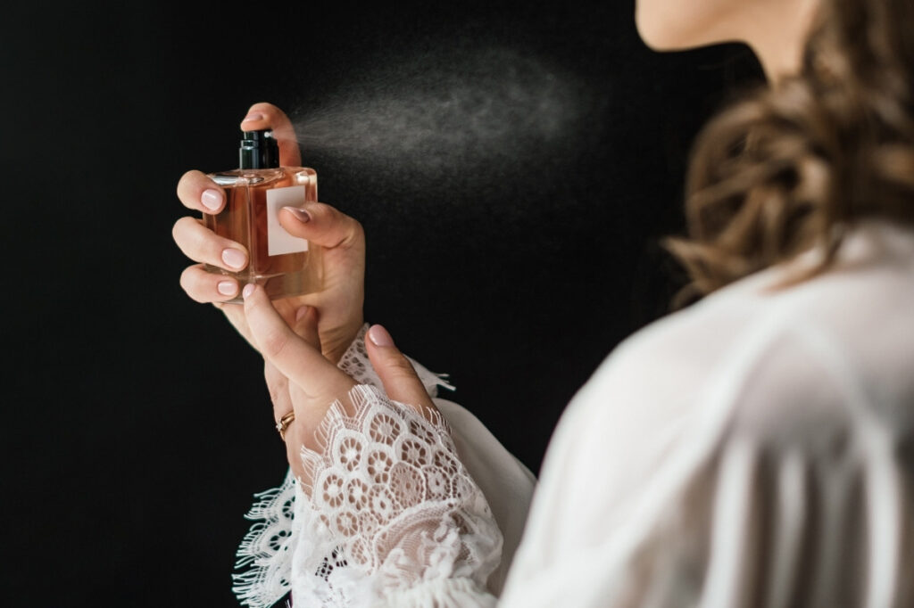 Fragrance in Skincare - Should you be Concerned? 19 An image of a woman spraying perfume