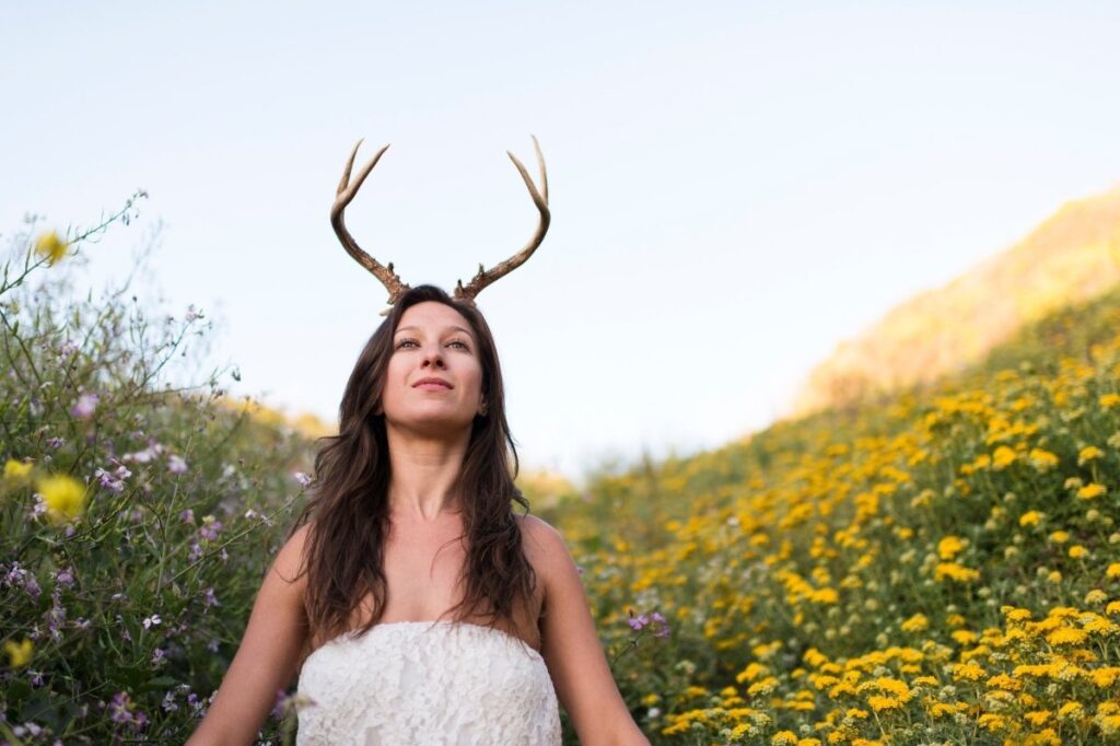 An image of a woman with horns of a deer, depicting a musk deer