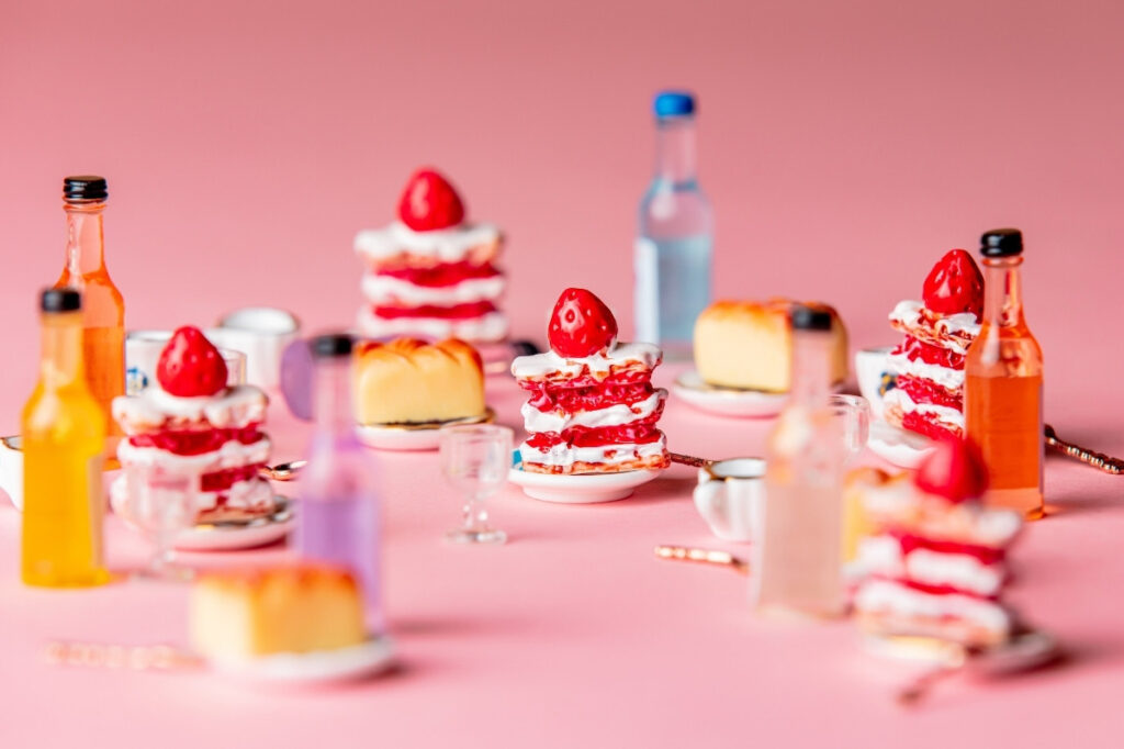 An image of miniature cakes and sweets on tabletop 