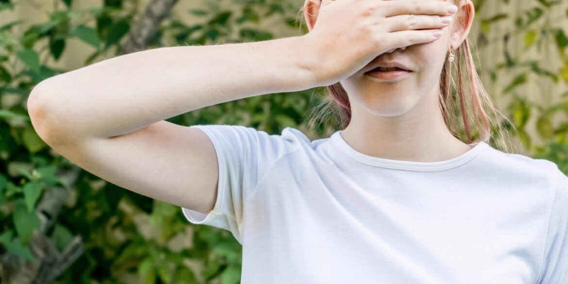 An image of a girl doing blind test of smell