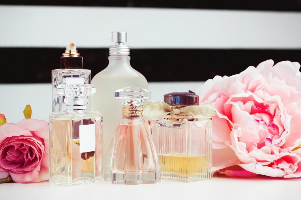 An image of different perfume bottles with flowers