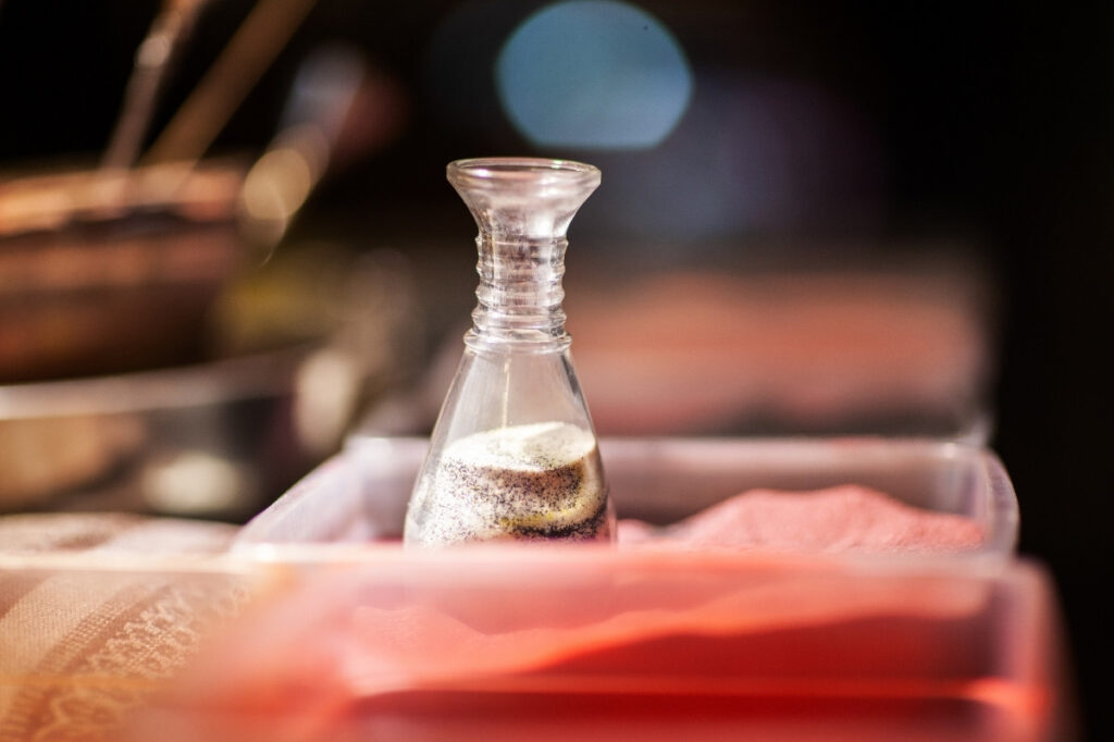 An image of a bottle with colored sand inside