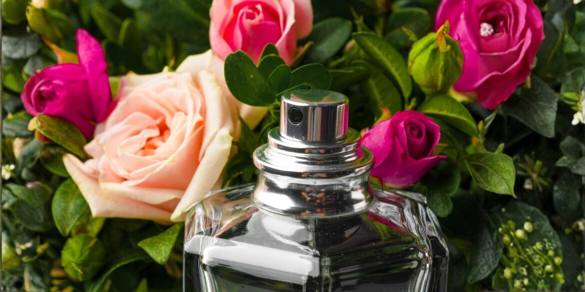 An image of some roses and a perfume in middle