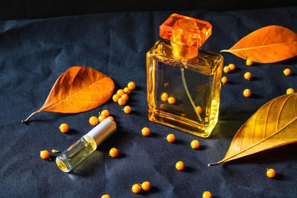 An image of a perfume bottle and amber pieces
