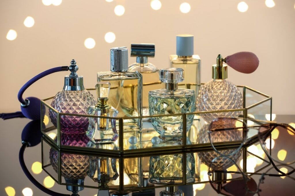 An image of different luxury perfumes on glass surface