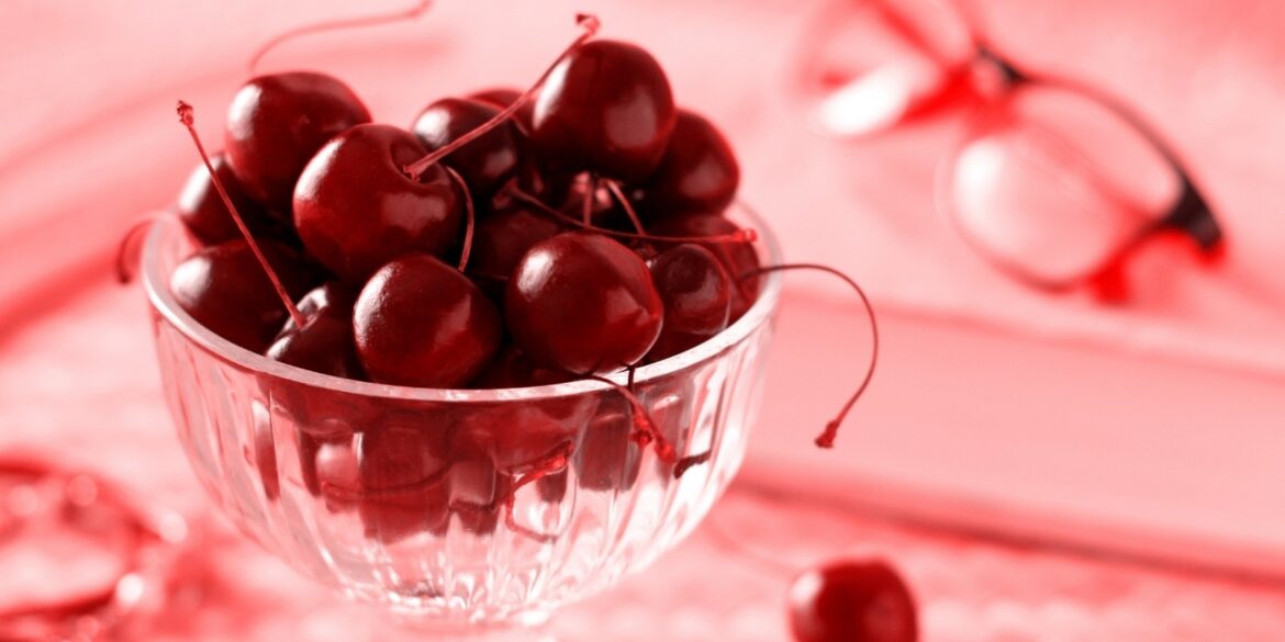 AN image of cherry fruits in a cup