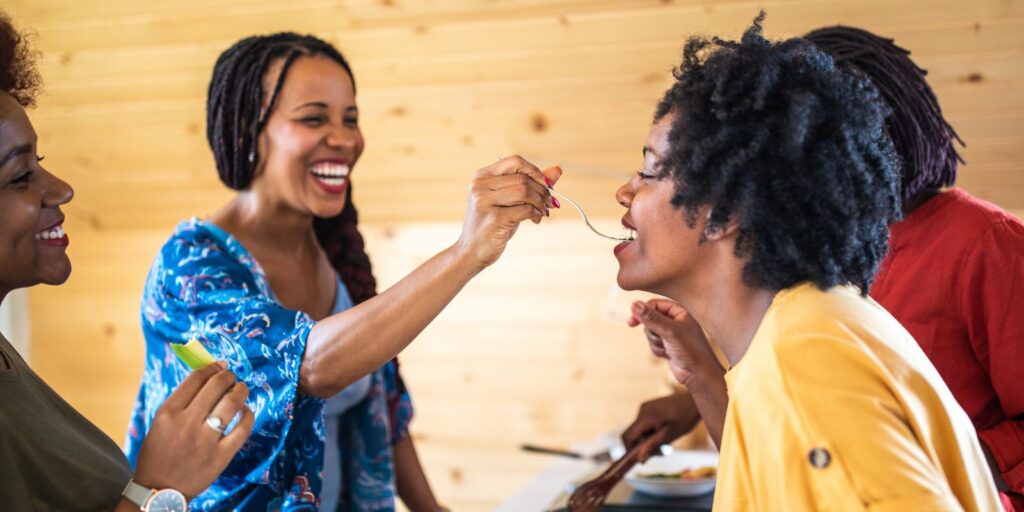 The Sensory Language We Use to Talk About Perfumes 20 An image of a woman feeding another woman