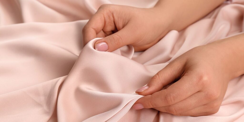 The Sensory Language We Use to Talk About Perfumes 21 An image of a silk cloth with a hand