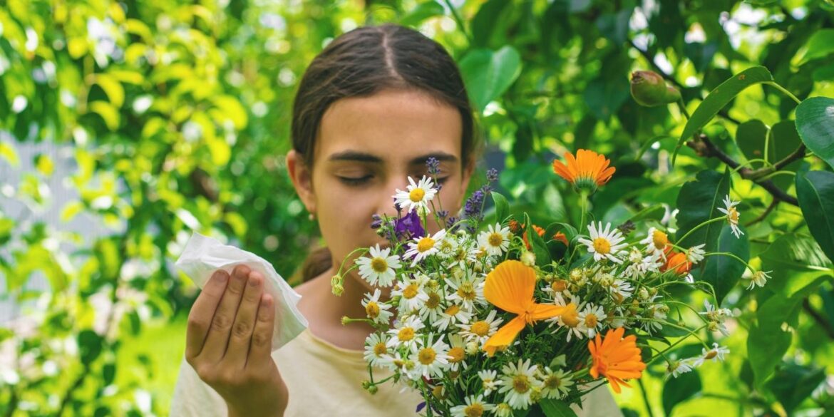 An image of a girl smelling flowers