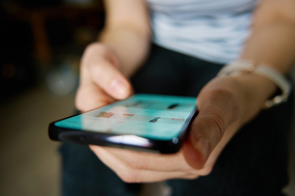 An image of a person using his mobile phone